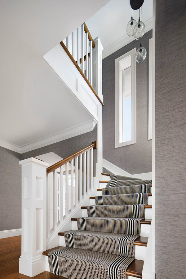 Stair Carpet - A darkly patterned stair carpet on a staircase surrounded by grey walls