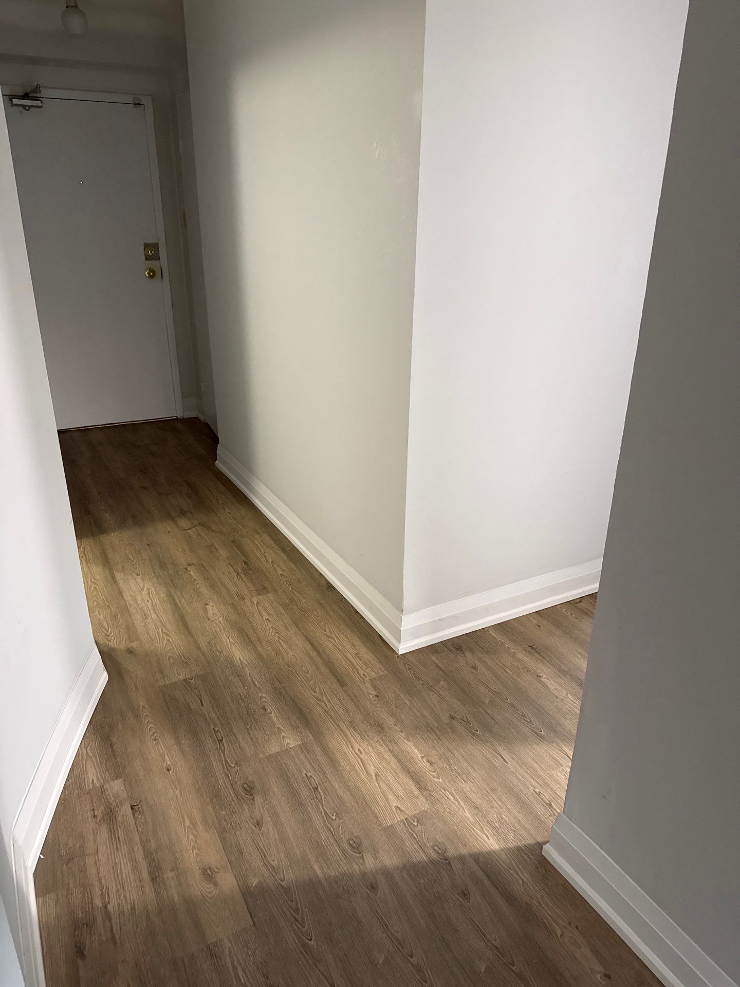 SmartDrop 7 Cashmere vinyl flooring running through a condominium hallway
